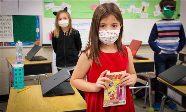 Girl smiles while dressed as a book character